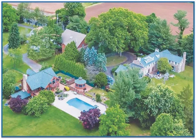 Aerial view of a suburban home with a backyard swimming pool.