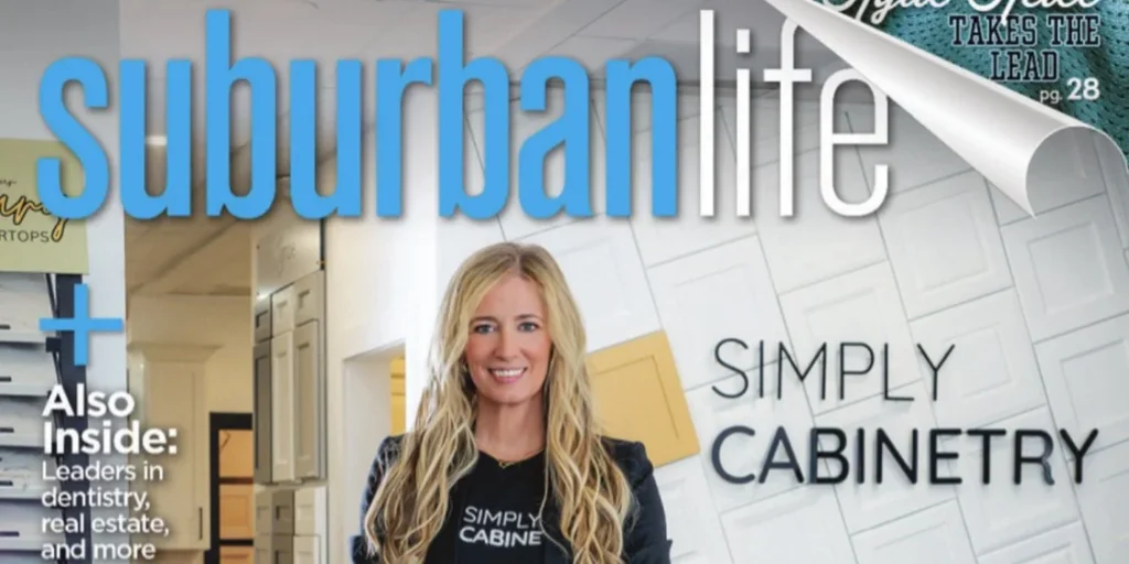 Blonde woman smiling in front of an Urban Life display sign.