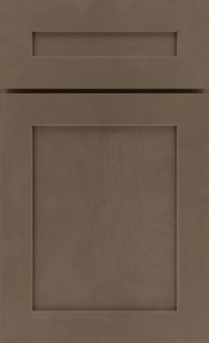 A brown wooden cabinet door with a simple, rectangular recessed panel design and a horizontal drawer front above.
