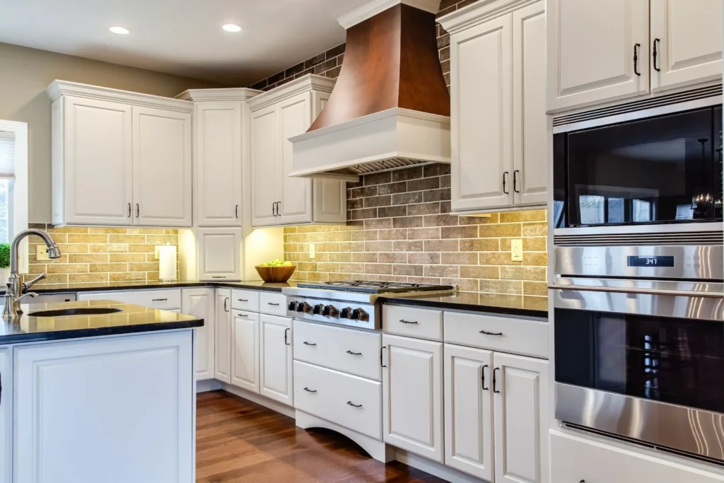 Wet bar area with lit glass front cabinets.