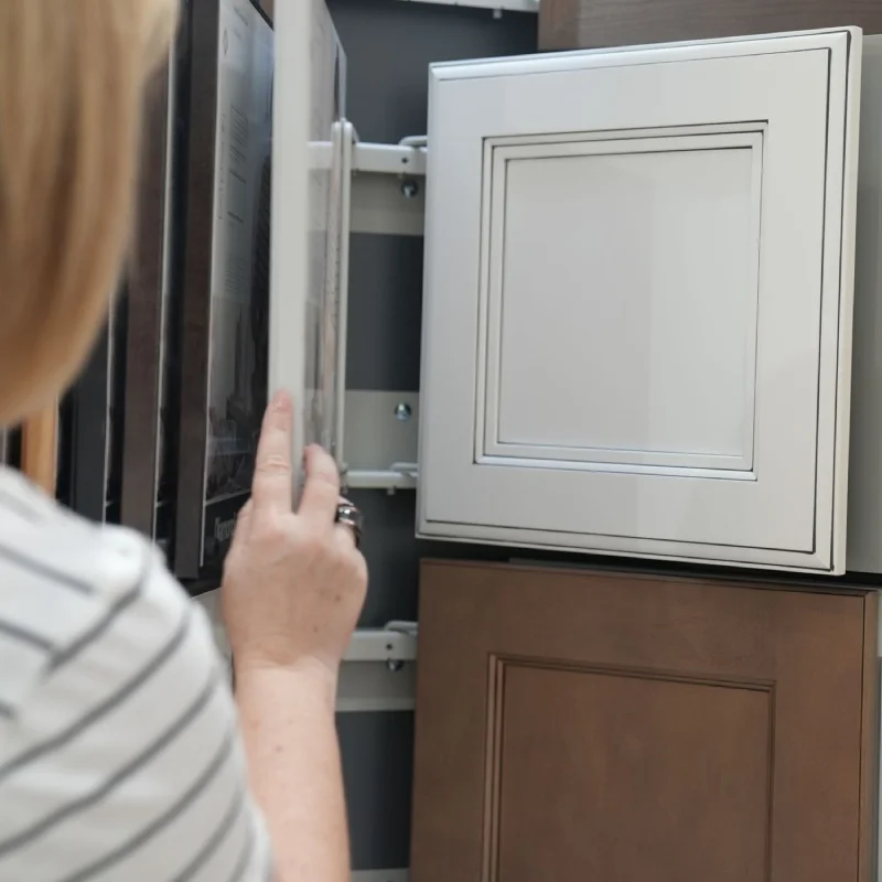 Hand opening a sliding display tracking mechanism containing cabinet style options.