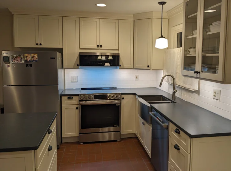 Classic kitchen space featuring cream-colored shaker cabinets and stainless steel appliances.