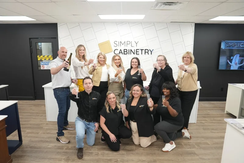 The Simply Cabinetry franchise team posing together inside their office.