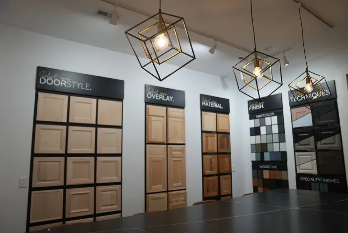 Cabinet showroom displaying vertical wooden door style sample boards.