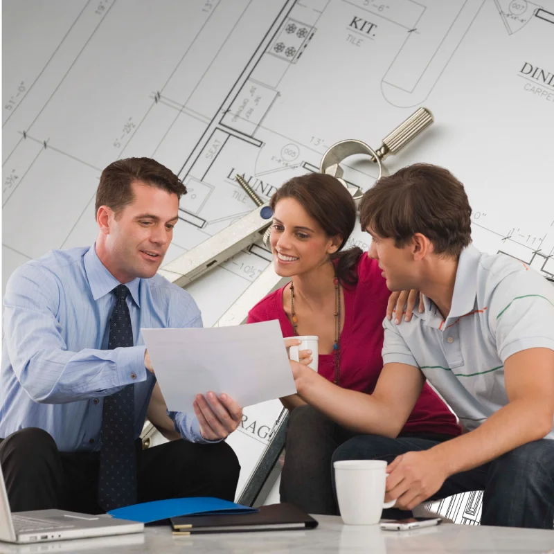 Designer reviewing floor plans with clients during consultation.