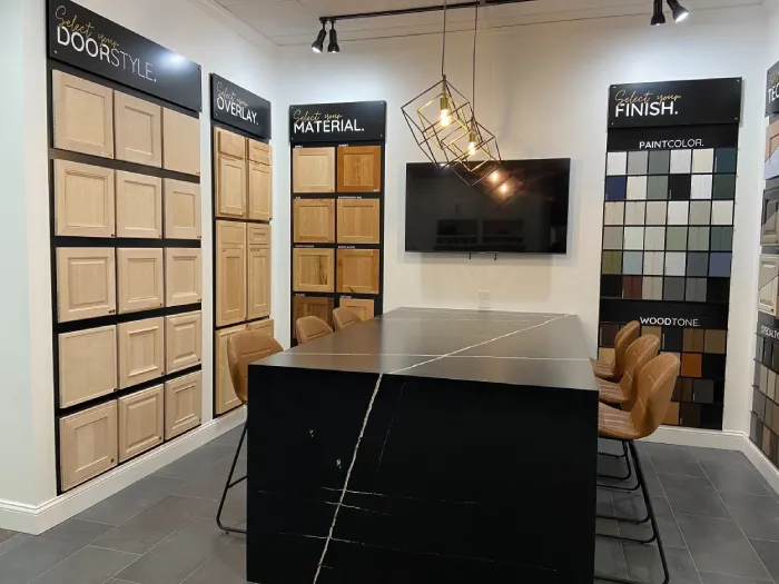 Design center interior featuring a dark island with seating.