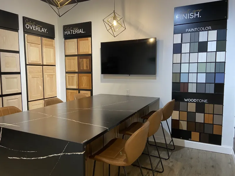 Showroom conference room table area with samples displaying a dark stone countertop.