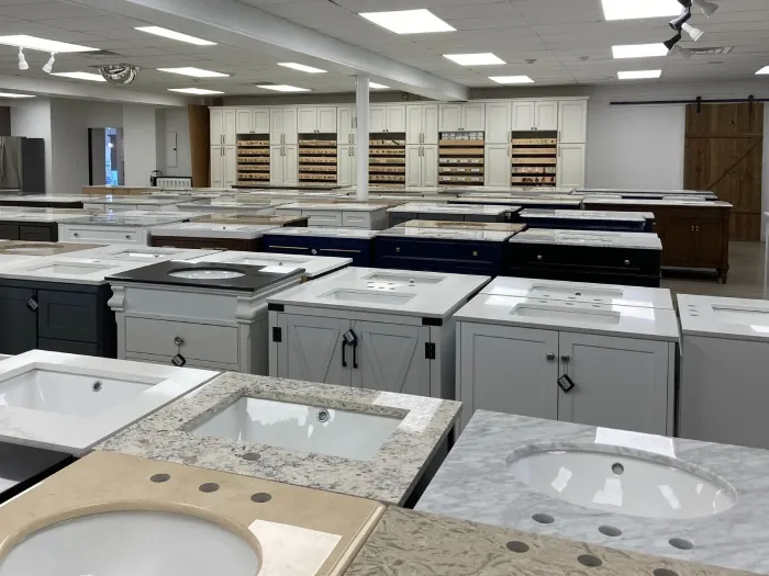 Showroom floor displaying rows of cabinet vanity display bases.