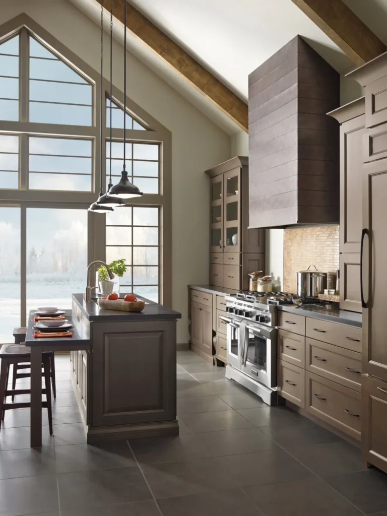 Luxury kitchen with a large wooden range hood and vaulted ceiling.