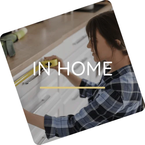 Angled design tile displaying a woman measuring kitchen cabinets overlayed with text reading In Home.