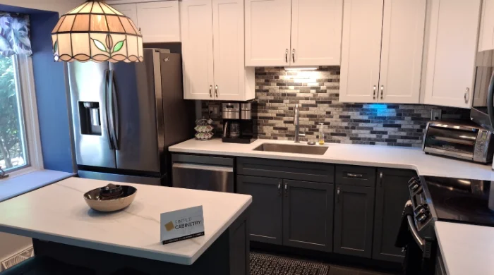 Two-tone contemporary kitchen design with white upper cabinets and charcoal gray lowers.