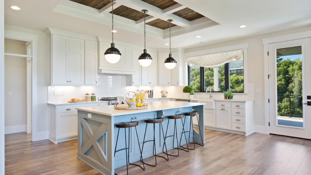 Spacious modern kitchen design featuring a light blue island base with matching wooden barstools.