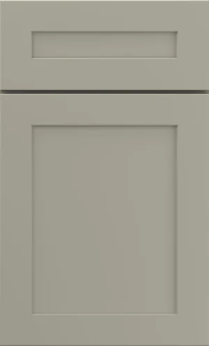 A straight-on close-up shot of an off-white shaker style cabinet door and drawer front.