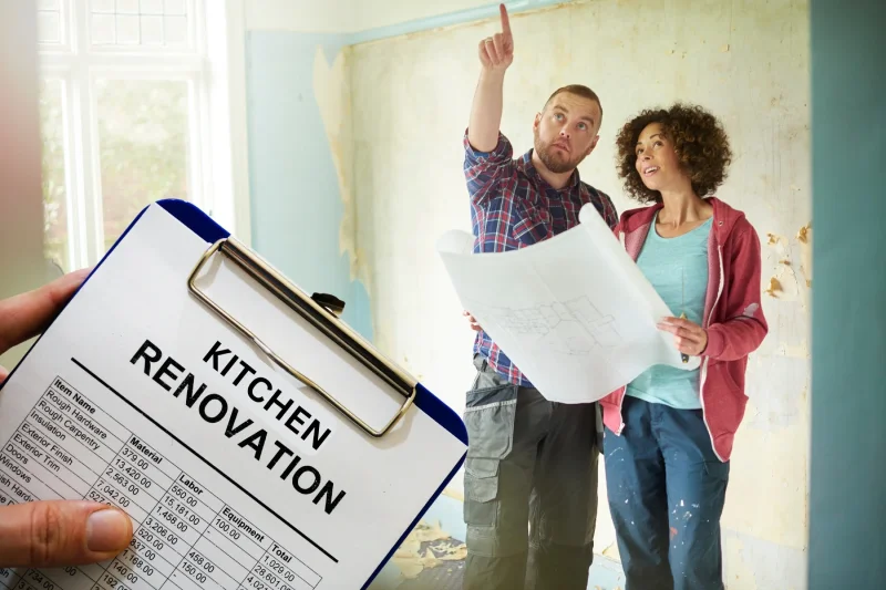 Contractor holding a renovation checklist while discussing plans with homeowners.
