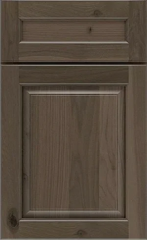 A close-up sample of a medium brown wood cabinet door with visible grain patterns.