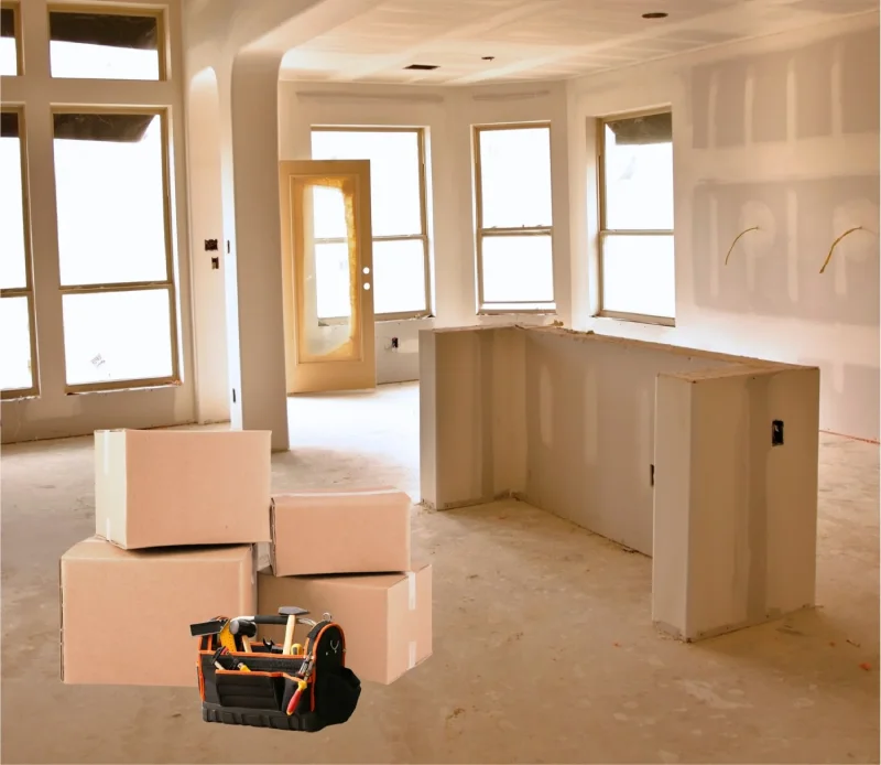 Unfinished kitchen remodel with cardboard boxes and tool bag.