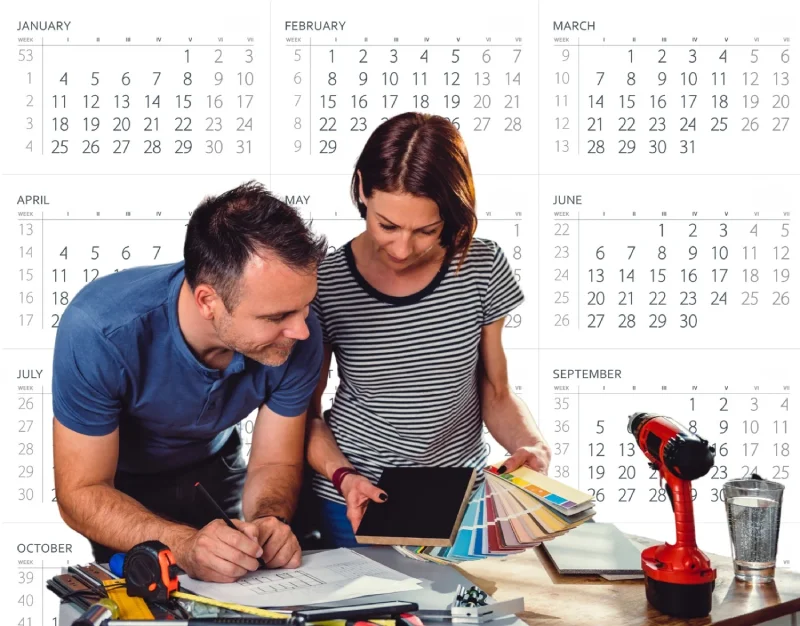 Couple planning renovation timeline with a tablet and color swatches.