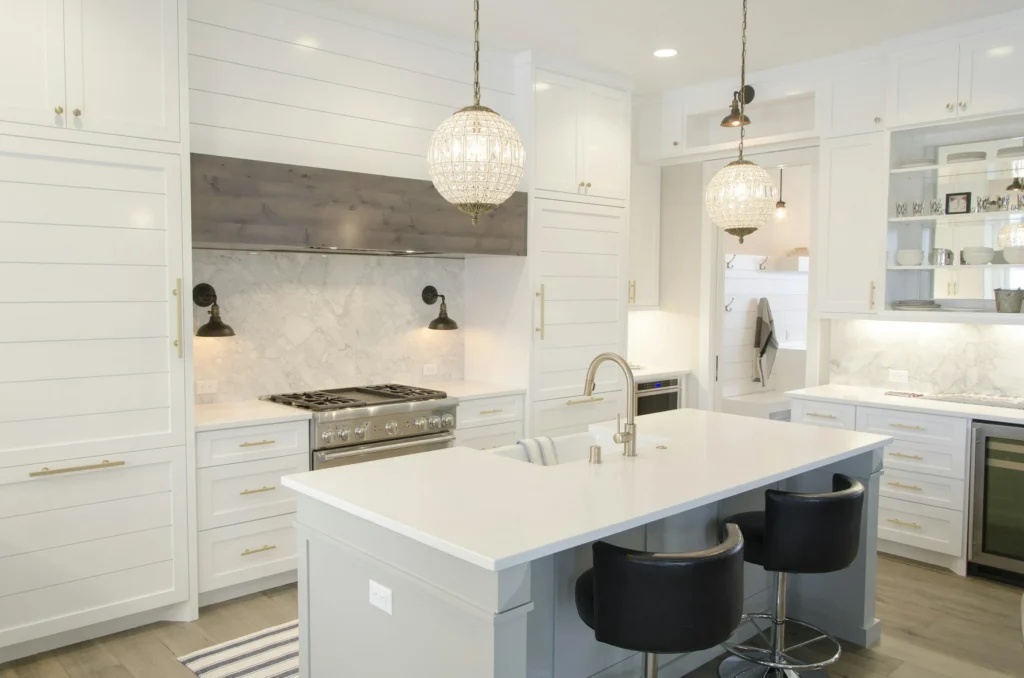 Bright transitional kitchen featuring white cabinets and a light grey island.